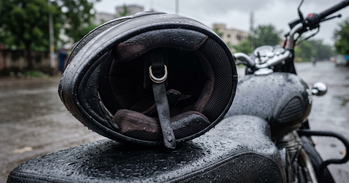 Inside of a damp motorcycle helmet with rain droplets around it